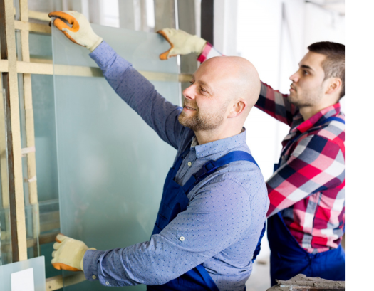 Professional glass installation team fitting interior glass panel